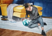 Schizofrenia dotyka nawet 25 mln osób na świecie Schizofrenia. Okładka poradnika "Otwarcie-o-schizofrenii". Obraz. Mężczyzna siedzi na dywanie patrzy na kulę ziemską